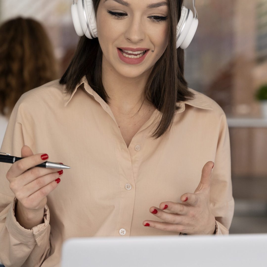 young-business-woman-working-office-with-laptop-headphones